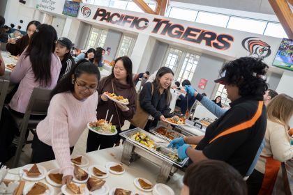 students enjoy thanksgiving meal