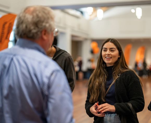 Student interacts with faculty members at University of the Pacific's Graduate Open House in Stockton, CA
